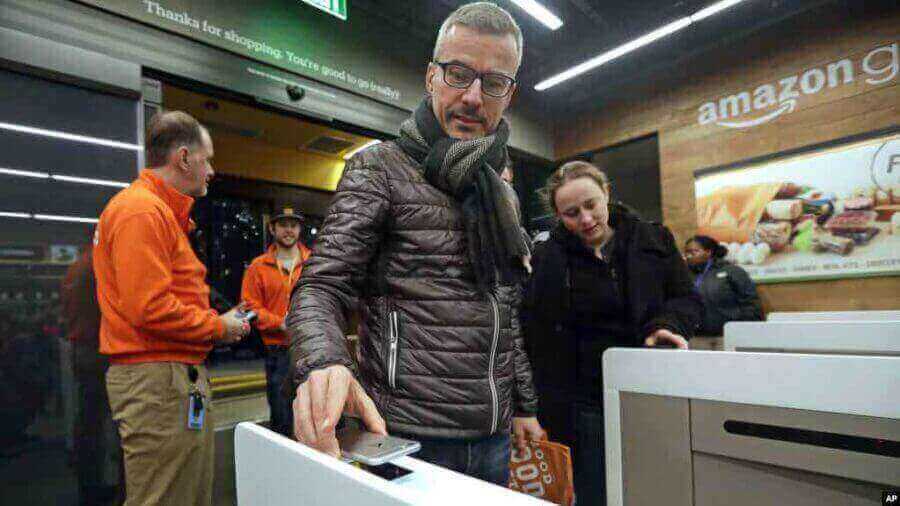 Customer of Artificial Intelligence powered Amazon Go Store, scans the code to enter the store and pay for the groceries 